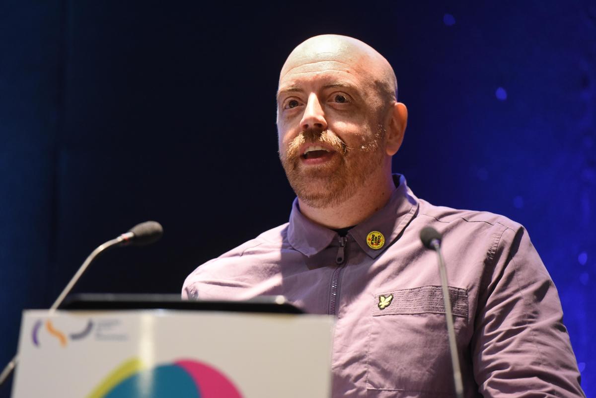 Close cropped photo of someone behind a lectern